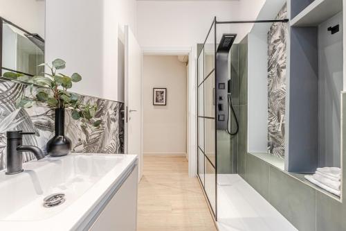 a bathroom with a sink and a shower at Discover Apartment in Livorno