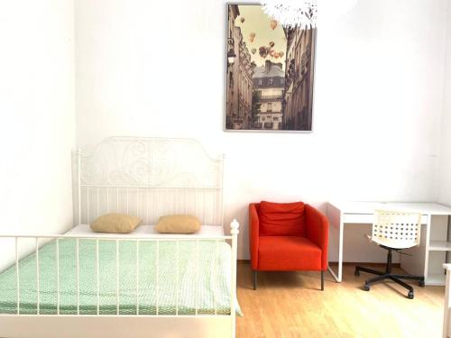 a bedroom with a bed and a desk and a chair at FlatMetro Rooms in Budapest