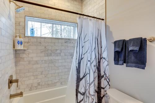 a bathroom with a shower curtain and a toilet at Lakefront Retreat at Waters Edge with Fire Pit! in Monteagle