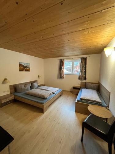 1 dormitorio con 2 camas y techo de madera en Berg Apart Anna, en Zaunhof