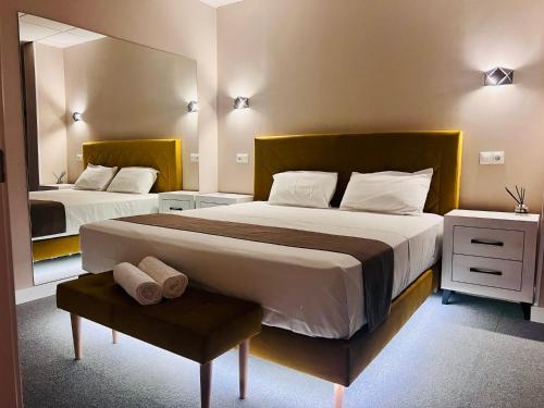 a bedroom with two beds and a mirror at Rooms Luxury Madrid in Madrid