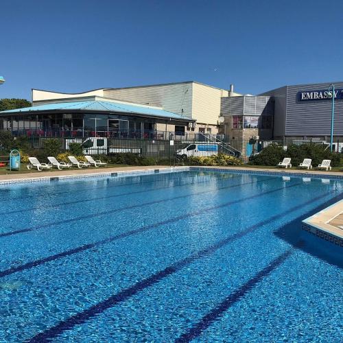 a large swimming pool in front of a building at The Singlecote Hotel in Lincolnshire