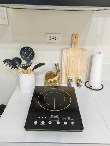 a counter top with a tablet on a table with other items at Ezzel’s Place at Marina Spatial Dumaguete City in Dumaguete