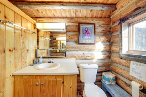 a bathroom with a sink and a toilet in a log cabin at Yellowstone Cabin Getaway Near National Park in Cliff Lake