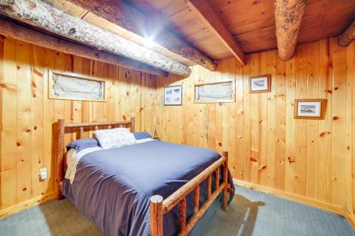 a bedroom with a bed in a wooden wall at Yellowstone Cabin Getaway Near National Park in Cliff Lake