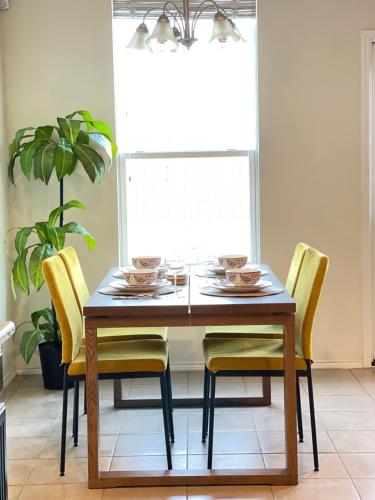uma mesa de jantar com cadeiras amarelas e uma planta em Family Perfect with Fireplace Vacation Home em Little Elm