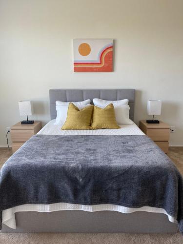 a bedroom with a large bed with two lamps at Family Perfect with Fireplace Vacation Home in Little Elm