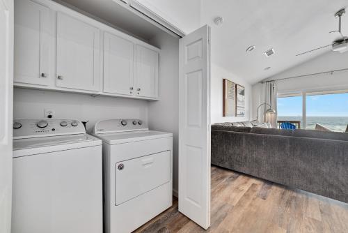 a kitchen with white cabinets and a counter top at Flip Flops & Sun in Gulf Shores