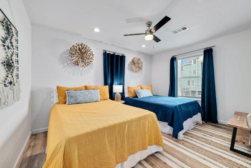 a bedroom with two beds and a ceiling fan at Flip Flops & Sun in Gulf Shores