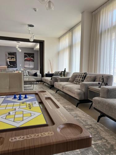 a living room with couches and a ping pong table at W muscat bay in Muscat