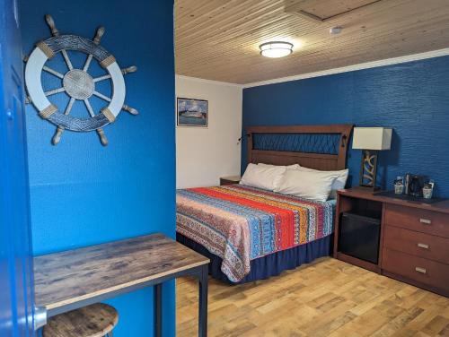 a bedroom with a bed and a wooden floor at Riverboat Inn & Suites in Madison