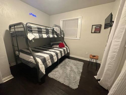 a bedroom with a bunk bed with a rug at The Cottage House in Hampton