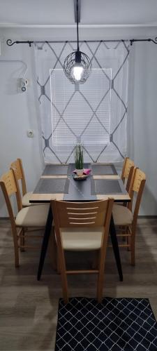 a dining room table with chairs and aendant light at Time4you in Čatež ob Savi