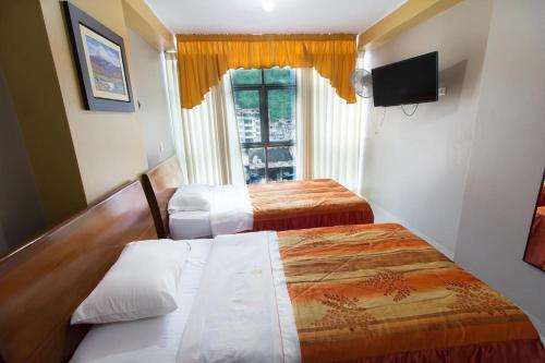 Habitación de hotel con 2 camas y ventana en Hotel Prince - Chanchamayo, en La Merced