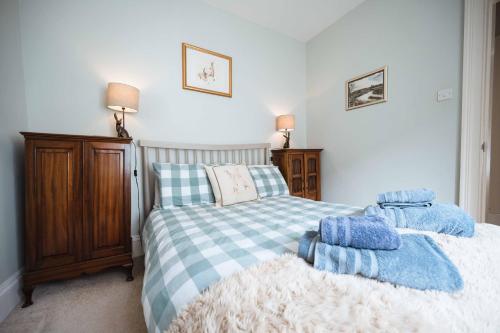 a bedroom with a bed with two towels on it at Blue House Berwick Upon Tweed in Berwick-Upon-Tweed