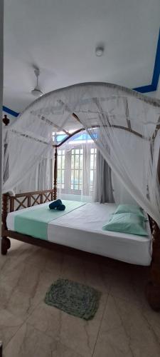 a large bed with a canopy in a room at The Pearl Palace in Weligama