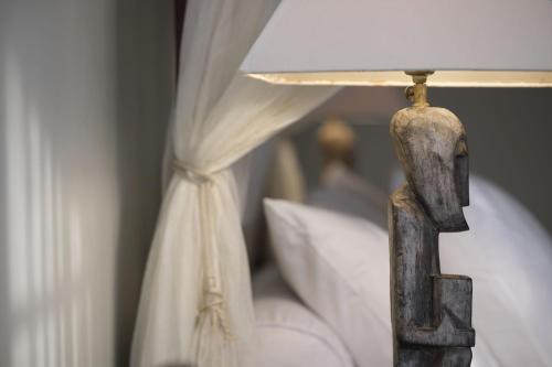 a bedroom with a bed with a lamp on it at The Damai in Lovina