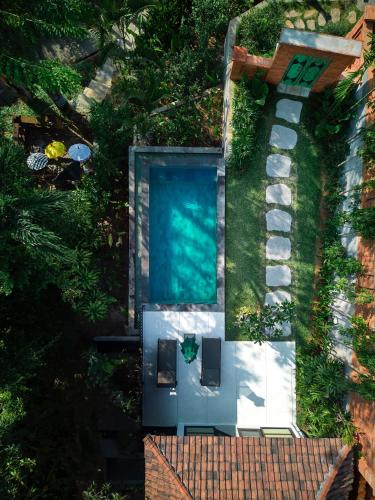 an overhead view of a swimming pool in a yard at The Damai in Lovina