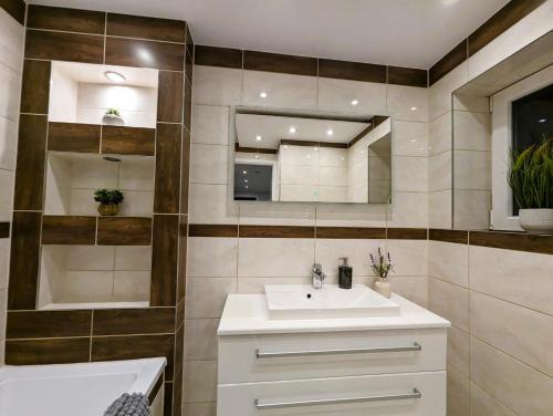 a bathroom with a sink and a mirror at 6 Guests * 4 Bedroom * Free Wi-Fi *Huntingdon in Huntingdon