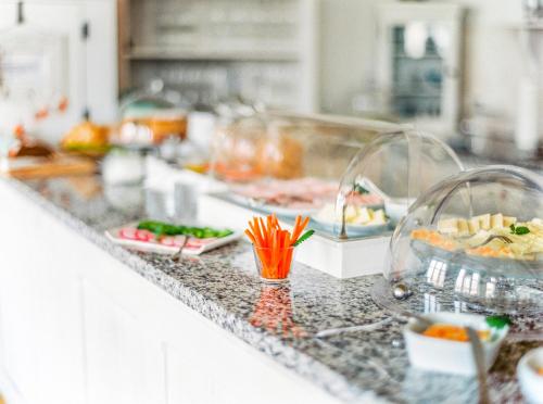 a kitchen counter with several plates of food on it at Cottage Gols in Gols