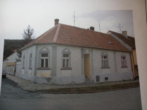 an old white house with a red roof at Alegria Natur Apartments in Mikulov