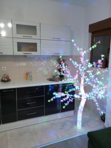 a christmas tree in a kitchen with lights on it at Apartman Old Town in Stolac
