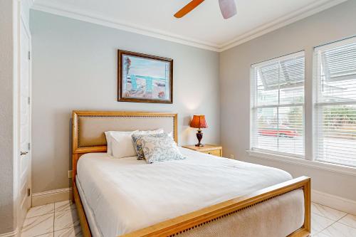 a bedroom with a large bed and two windows at Miramar Beach Villas #946B in Destin