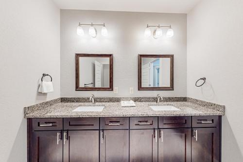 a bathroom with two sinks and two mirrors at Miramar Beach Villas #946B in Destin