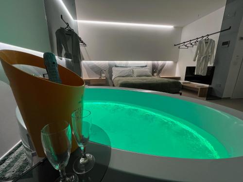 a tub in a living room with glasses on a table at Seacity Suite & Stay in Monopoli