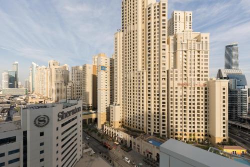 a view of a large city with tall buildings at Palmar One Bedroom with Private Beach! in Dubai