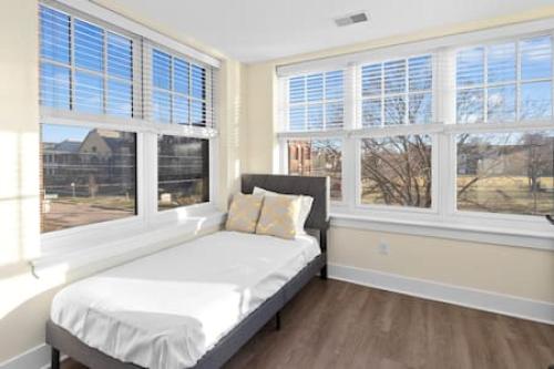 a bedroom with a bed in a room with windows at Affordable 1-BR by DMC Detroit in Detroit