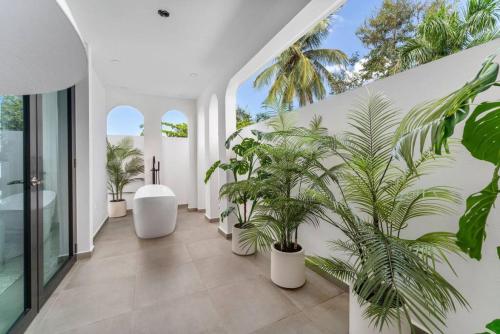 a hallway with potted plants on the wall at Casa Loba Luxe Apartment with pool and ocean views in Rincon
