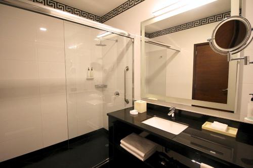 a bathroom with a shower and a sink and a mirror at Hilton Garden Inn Lima Surco in Lima