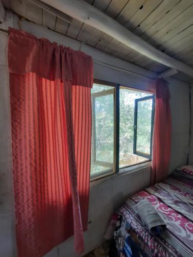 a bedroom with a red curtain and a window at Felix Felicis 