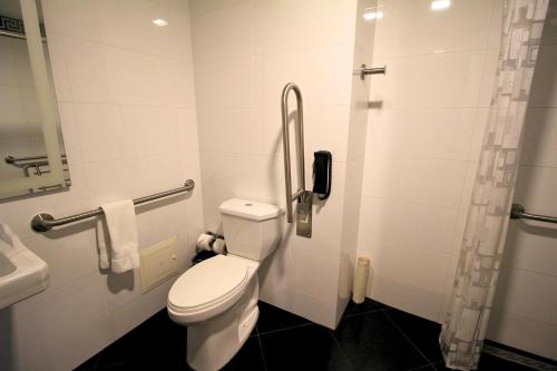a small bathroom with a toilet and a sink at Hilton Garden Inn Lima Surco in Lima