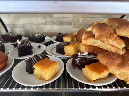 a bunch of different types of pastries on plates at Nautica Hotel Apartments in Stavromenos