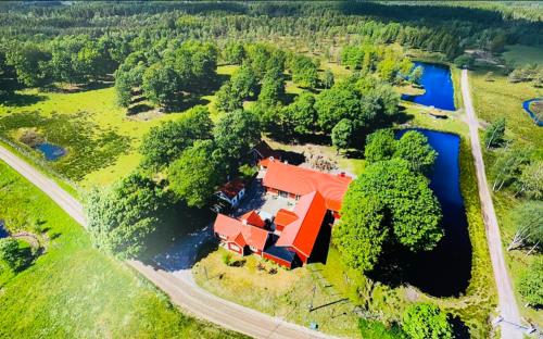 an aerial view of a house and a river at Stuga - Ulvereds Hjorthägn in Laholm