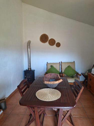 a dining room with a wooden table and a stove at Refúgio dos Sapinhos in Silves