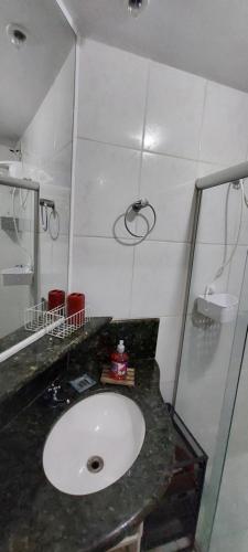 a bathroom with a sink and a shower at Apartamento Mobiliado - Botafogo in Rio de Janeiro