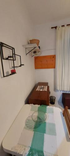 a small room with a bed and a table at Apartamento Mobiliado - Botafogo in Rio de Janeiro