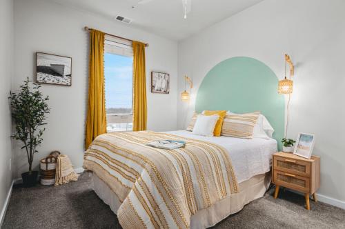 a bedroom with a large bed and a window at NEW Shoreline 401 2BR Condo Near Downtown and Bay in Traverse City