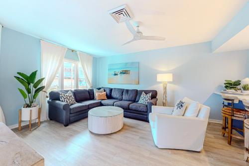 a living room with a couch and a table at Port O' Call G-303 in Isle of Palms