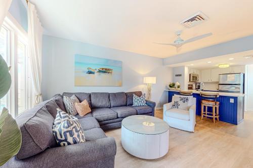 a living room with a couch and a table at Port O' Call G-303 in Isle of Palms