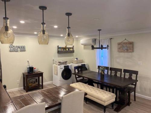 a dining room with a table and chairs and a kitchen at Beautiful farmhouse in Fernandina Beach in Fernandina Beach