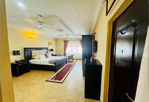 a hotel room with a bed and a hallway at Silent night in Kumasi
