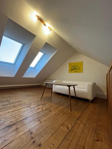 Habitación en el ático con mesa y sofá en Schönes Appartment in Zentrumsnähe, en Graz