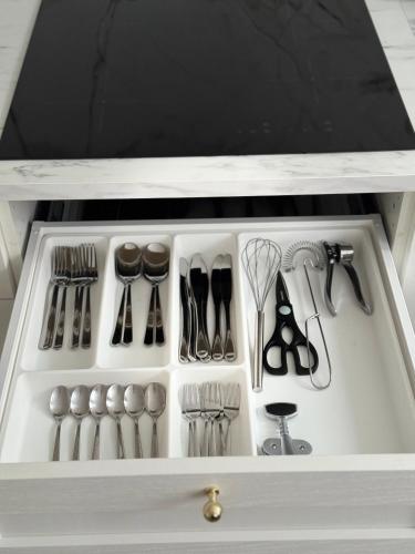 a drawer filled with utensils in a kitchen at Apartamentai Jums in Telšiai