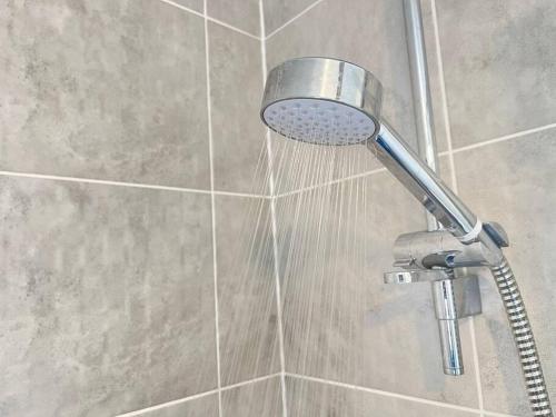 a shower with a shower head in a bathroom at Modern Flat near Birmingham Uni with Wi-Fi & Parking in Birmingham