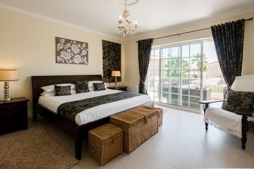 a bedroom with a bed and a large window at Casa Lago in Quinta do Lago