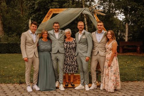 a group of people posing for a picture at a wedding at Restaurant - Pension Im Pfenn in Irrhausen